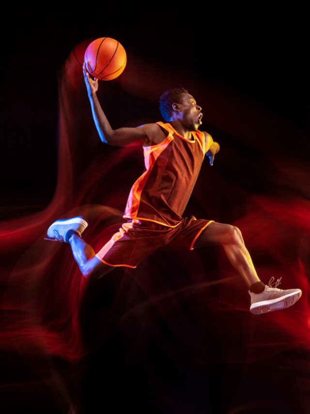 Young basketball player against dark background